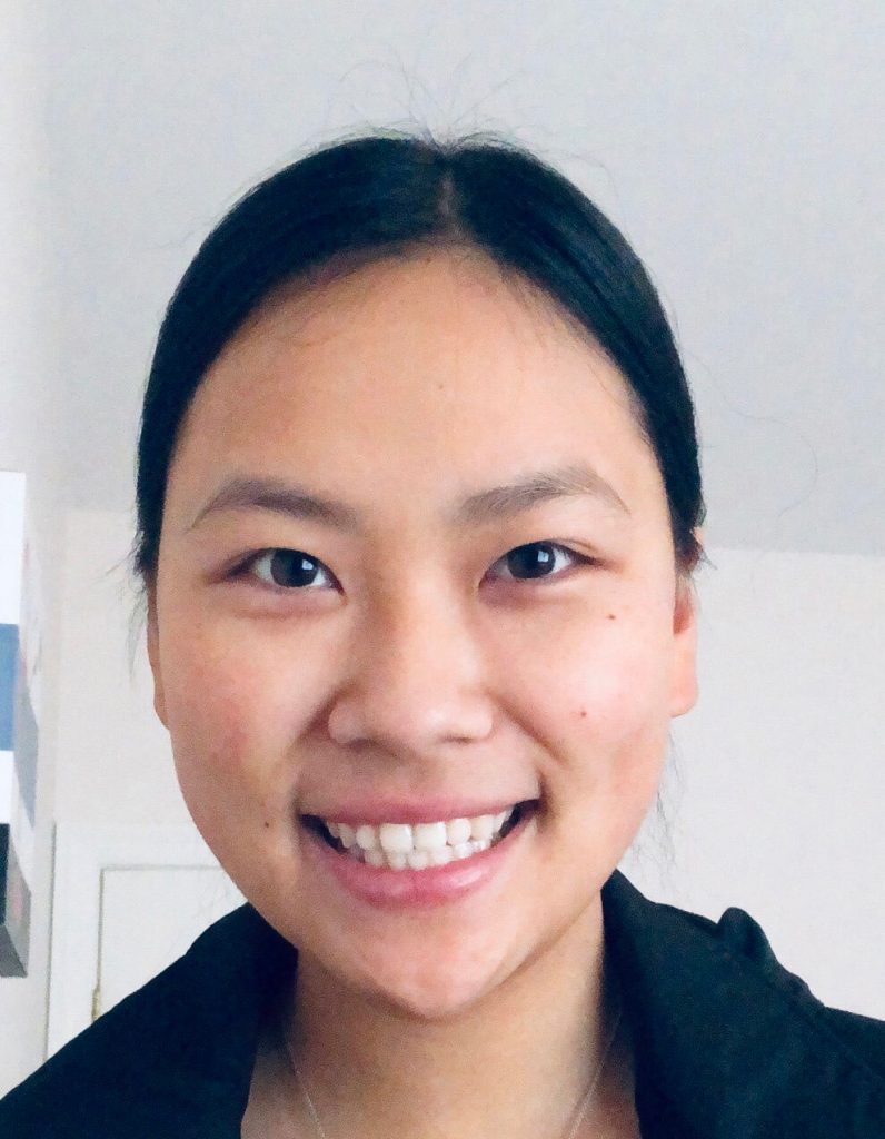 Young Asian woman smiling at the camera in a well-lit room for the 2020 Impact Report.